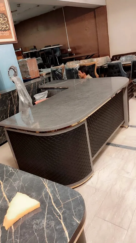 L-shaped reception counter with quilted front panels, made by Lahore Carpenter in Lahore